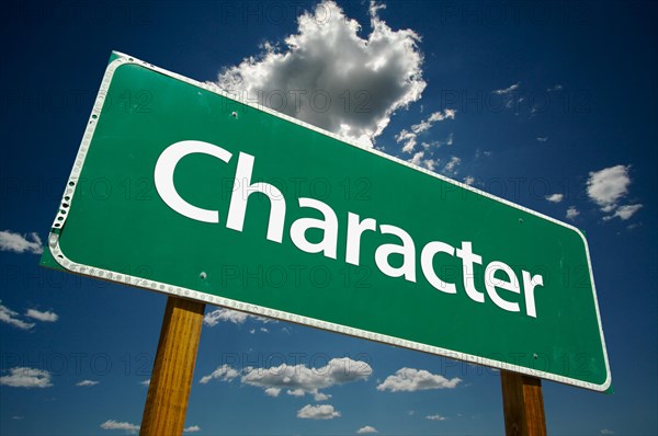 Character road sign with dramatic blue sky and clouds