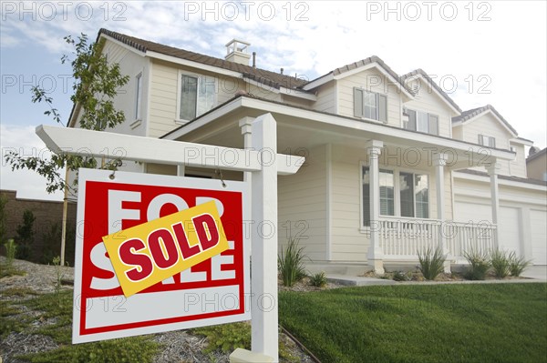 Sold home for sale real estate sign in front of new house