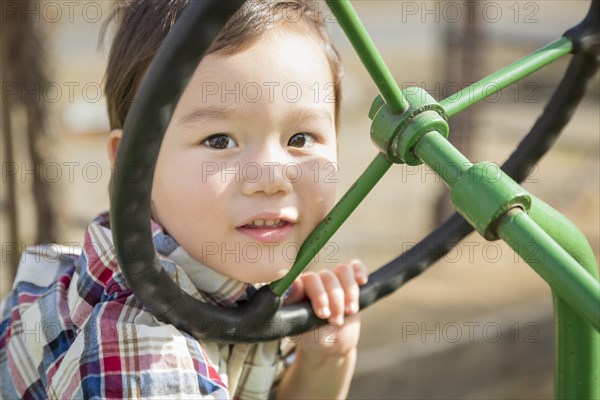 Adorable mixed-race young boy playing on the tractor at the pumpkin patch