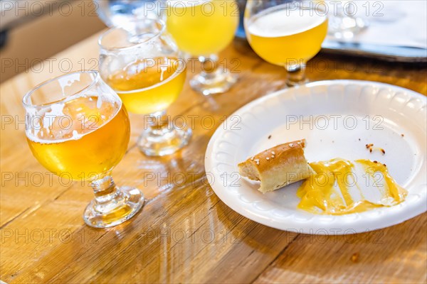 Abstract of small glass of micro brew beers and warm pretzels on bar