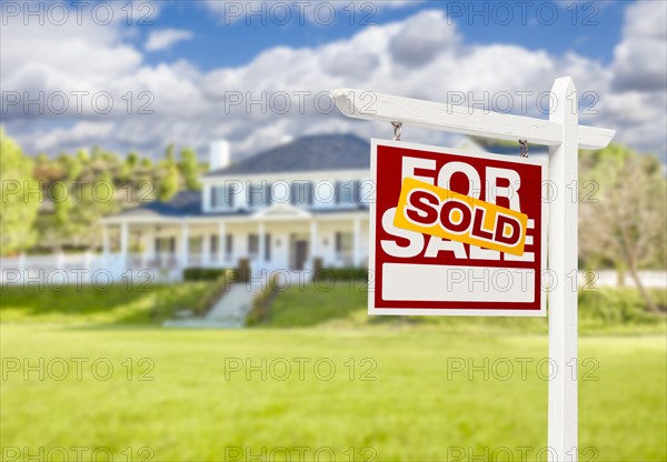 Sold home for sale real estate sign in front of beautiful new house