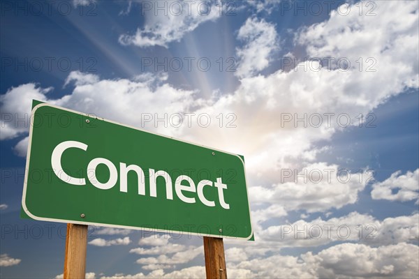 Connect green road sign with dramatic clouds and sky