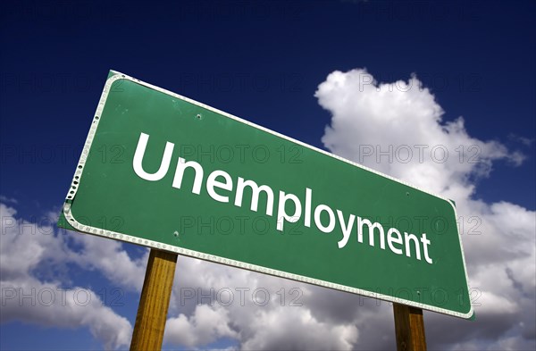 Unemployment road sign with dramatic clouds and sky