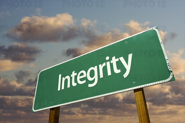 Integrity green road sign with dramatic blue sky and clouds