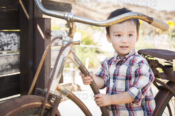 Cute mixed-race young boy having fun on the bicycle