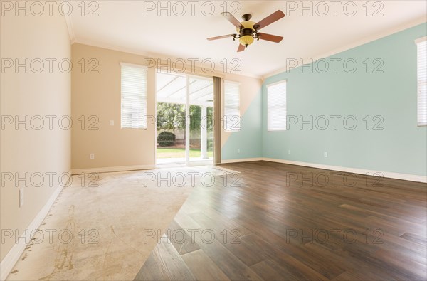 Empty room with cross section showing before and after with new wood floor and paint