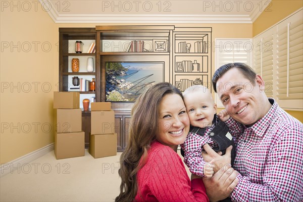 Young family in room with moving boxes and drawing of entertainment unit on wall