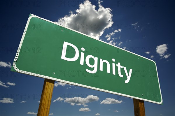 Dignity road sign with dramatic clouds and sky