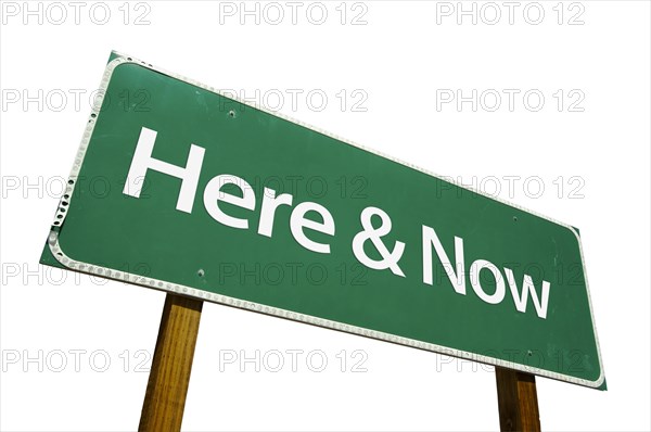 Here and now green road sign isolated on a white background with clipping path