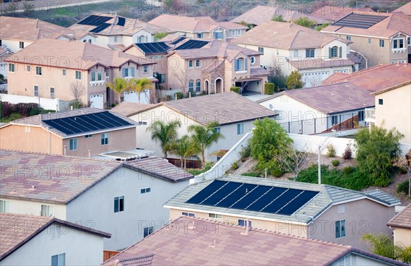 Contemporary neighborhood roof tops view with solar panels
