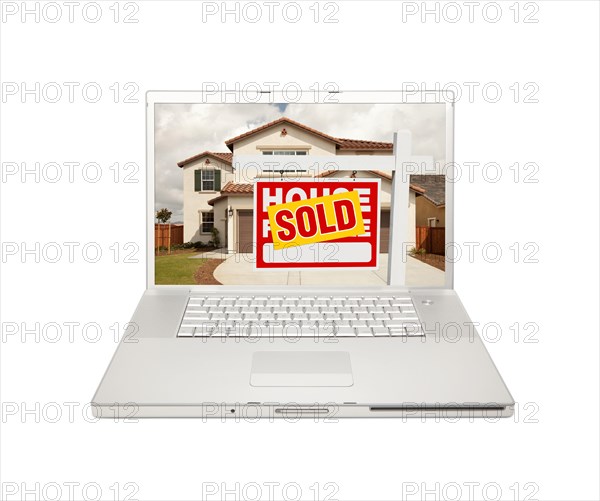 Sold for sale real estate sign on computer laptop isolated on a white background