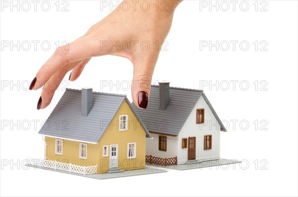 Female hand reaching for house isolated on a white background