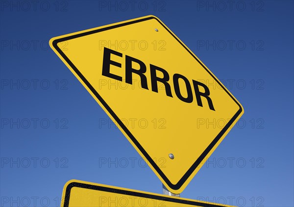 Yellow error road sign against a deep blue sky with clipping path