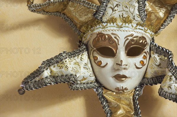 Beautiful venetian mask on light yellow wall