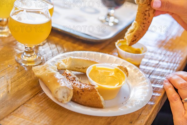 Woman enjoys warm pretzels and micro brew beer