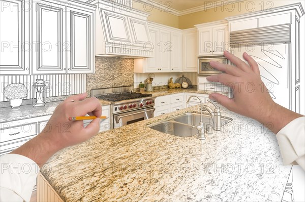 Male hands sketching with pencil A custom kitchen with photo showing through