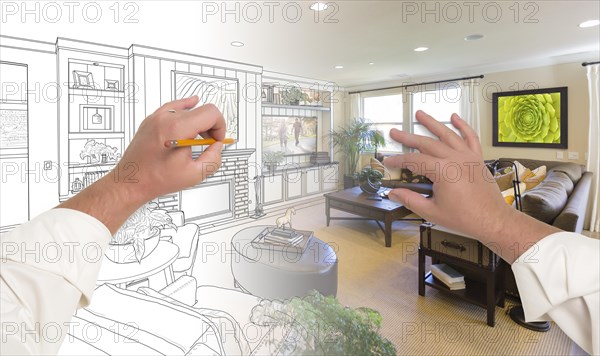 Male hands drawing custom living room design gradating into photograph