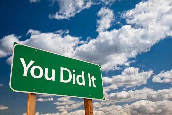 You did it green road sign with dramatic clouds and sky