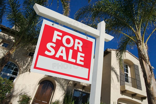 Home for sale sign in front of new house