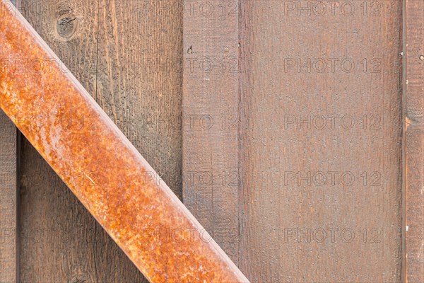 Wooden wall with rusty metal beam background