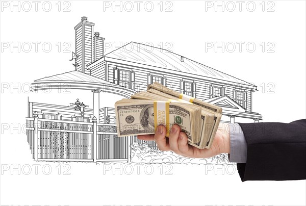 Hand holding thousands of dollars in cash over house drawing