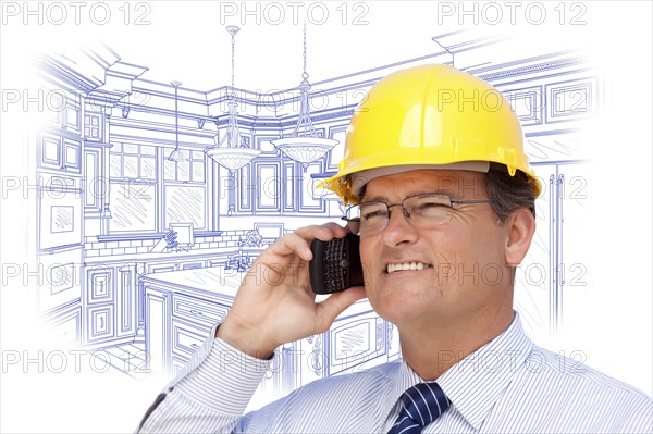 Contractor in hardhat on cell phone over custom kitchen drawing on white