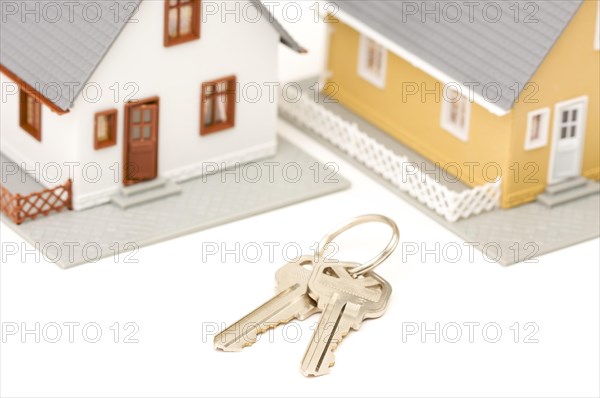 Keys and houses isolated on a white background. focus is on the keys