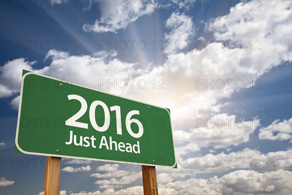 2016 just ahead green road sign against dramatic clouds and sky