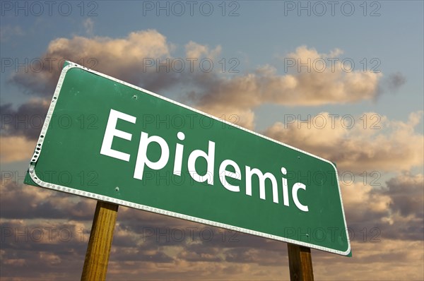 Epidemic green road sign with dramatic clouds and sky