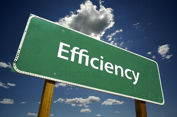 Efficiency green road sign over dramatic blue sky and clouds with clipping path