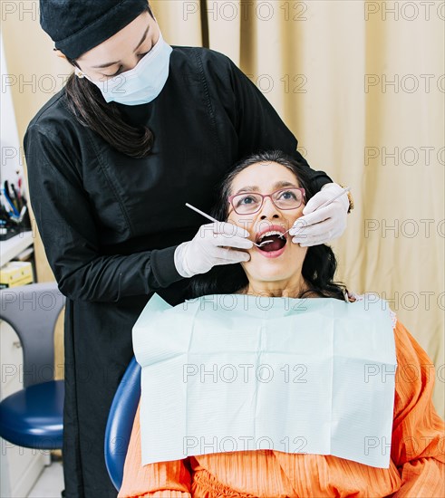 Dentist performing dental checkup