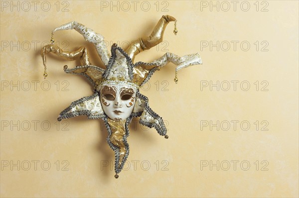 Beautiful venetian mask on light yellow wall