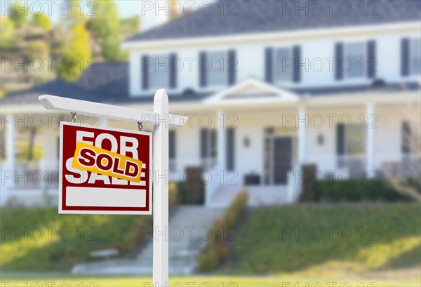 Sold home for sale real estate sign in front of beautiful new house