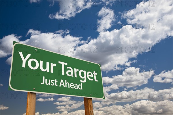Your target green road sign over dramatic clouds and sky