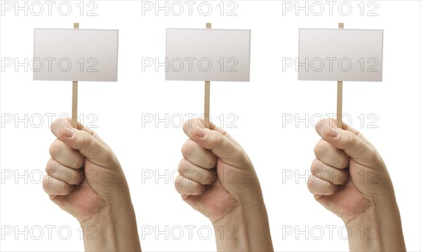 Three blank signs in male fists isolated on a white background