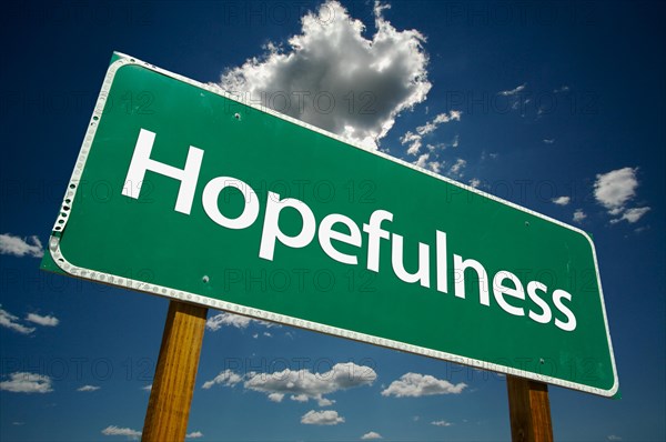 Hopefulness green road sign with dramatic clouds and sky