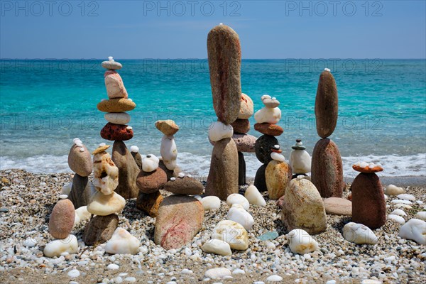 Concept of balance and harmony. Stones pebbles stacks on the beach coast of the blue sea in the nature. Meditative art of stone stacking