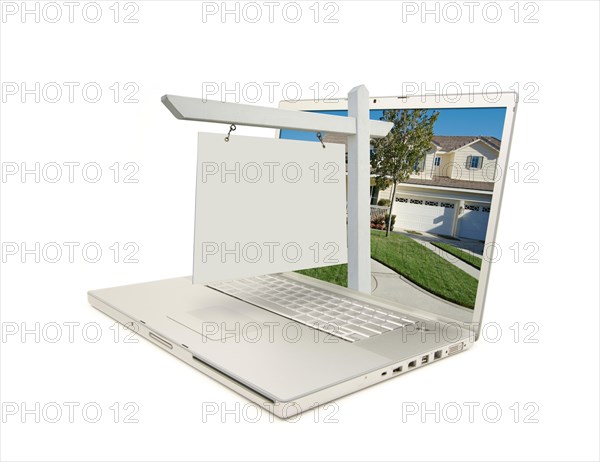 Blank real estate sign & new home on laptop isolated on a white background
