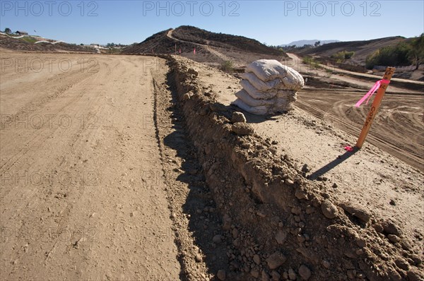 Sandbags & marker sticks at construction site