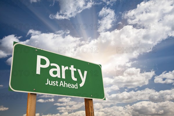 Party green road sign with dramatic clouds and sky