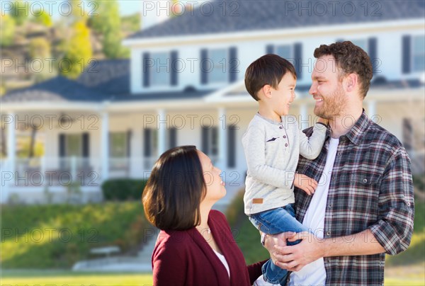 Young mixed-race caucasian and chinese family in front of custom house