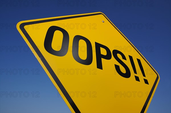 Yellow oops! road sign against A dramatic blue sky with clipping path