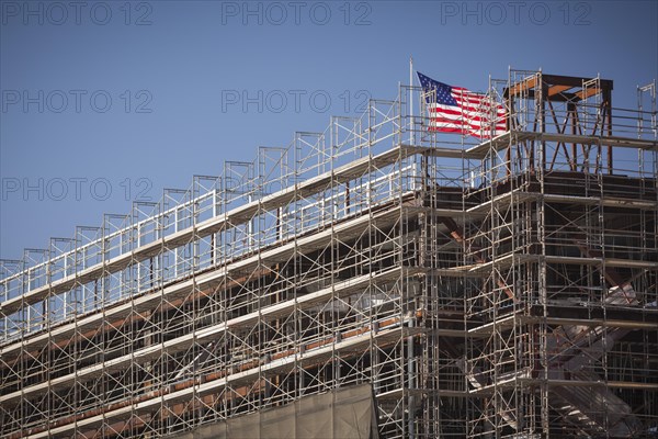 Majestic american flag flying on top of new building construction