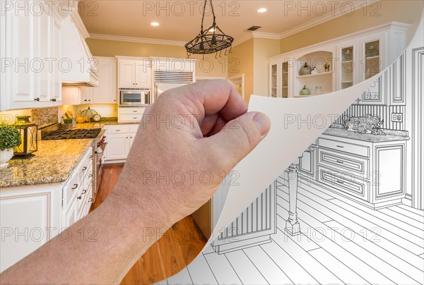 Male hand turning page of custom kitchen photograph to drawing underneath