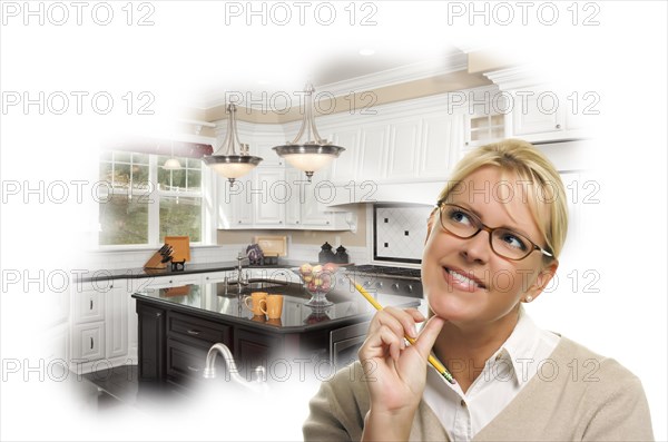 Daydreaming woman with pencil over custom kitchen photo in thought bubble