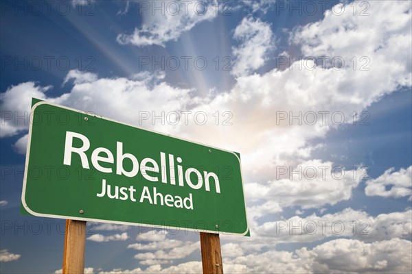 Rebellion green road sign with dramatic clouds