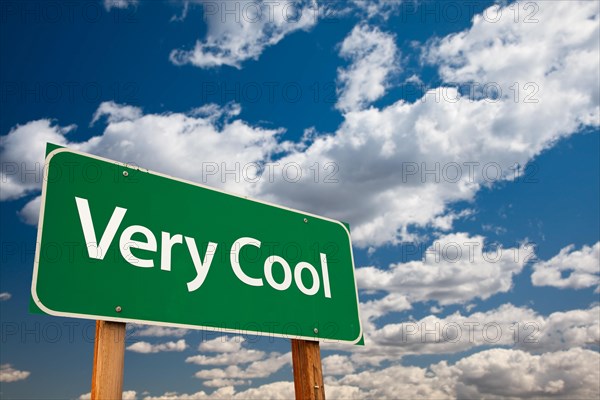 Very cool green road sign with dramatic clouds and sky