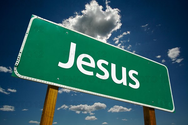 Jesus road sign with dramatic clouds and sky