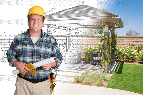 Male contractor with house plans wearing hard hat in front of custom pergola patio covering drawing photo combination