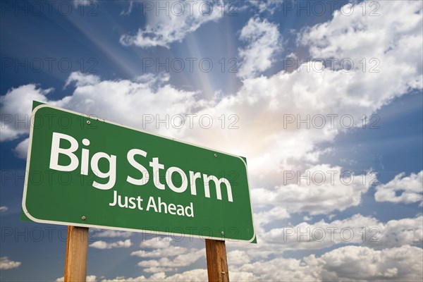 Big storm green road sign with dramatic clouds and sky